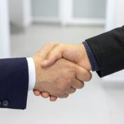Business handshake representing trust and commitment in a signature coaching program