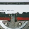 Close-up of a vintage typewriter with the words “Stories matter” typed on paper—symbolizing the power of storytelling in coaching and personal transformation.