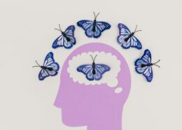 Creative coaching with art therapy concept showing blue butterflies emerging from a paper-cut human mind, symbolizing emotional expression and personal transformation.